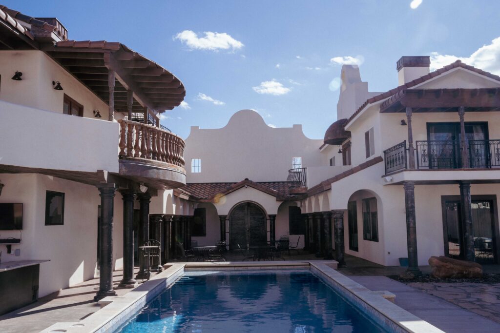 salt water pool with view of courtyard of hacienda style house