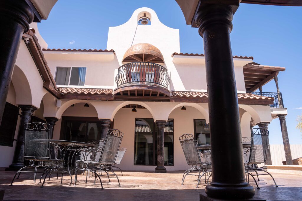 stunning Romeo and Juliet balcony and towering cantera stone columns around the courtyard 